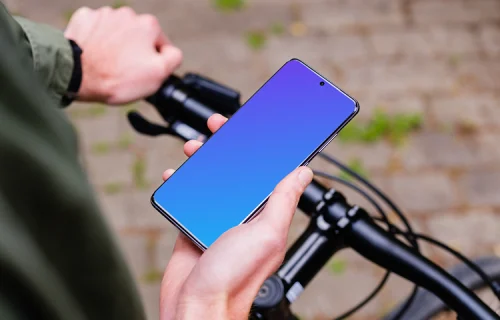 Holding bike in one hand with Samsung S20 mockup in the other