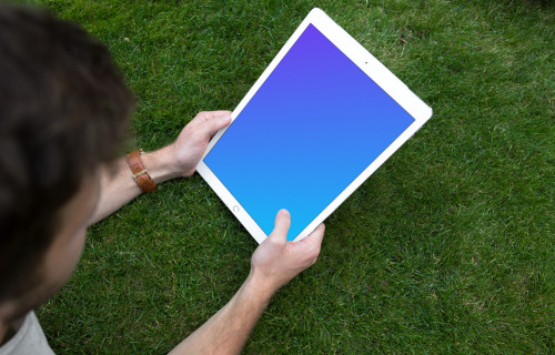 Holding iPad Pro mockup on the green background