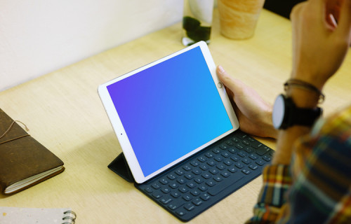 Holding iPad Pro mockup with keyboard