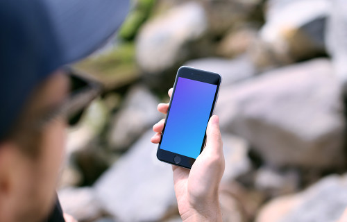 Holding iPhone 6s mockup during sunny day