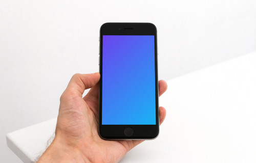 Holding iPhone 6s mockup in the office