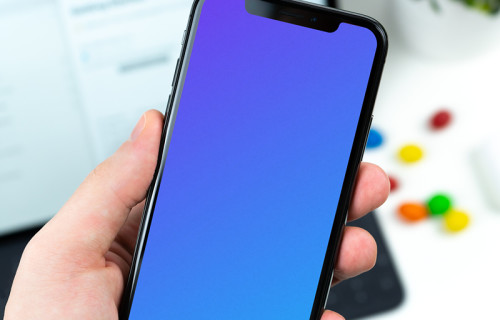 Holding iPhone XS mockup