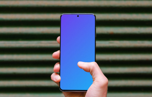 Holding Samsung Galaxy S20 mockup against metal fence