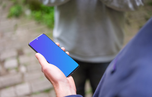 Holding Samsung Galaxy S20 mockup next to a friend