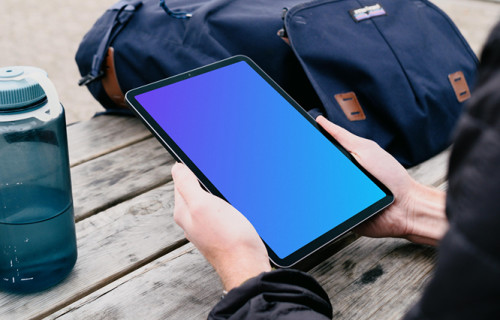 iPad Air mockup in a user’s hand in a park