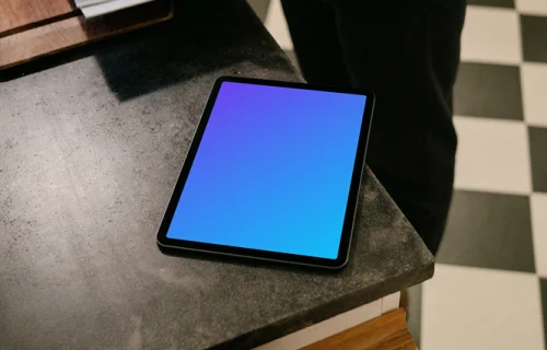 iPad Air mockup on a black table next to a user