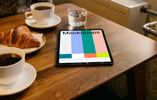 iPad Air mockup on a brown table with a plate of food at the side