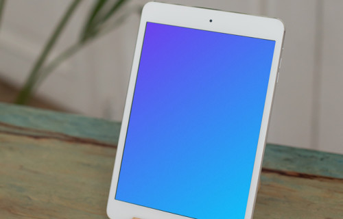 iPad Mini mockup on wooden stand and placed on a table