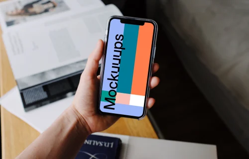 iPhone 12 Pro mockup held by user over textbooks