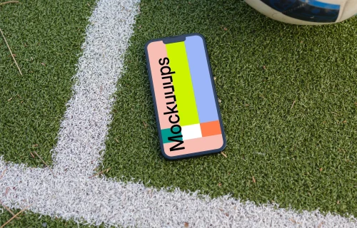 iPhone 13 mockup on the grass