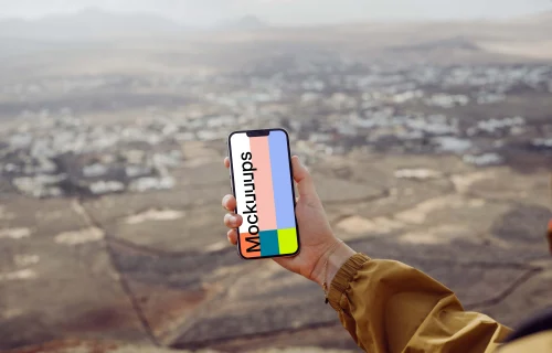 iPhone 13 Pro mockup held by a user above a field