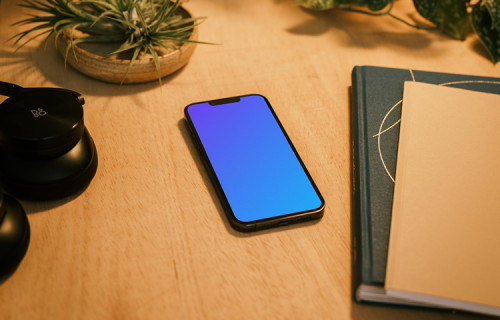 iPhone 13 Pro on a table with potted plants in the background