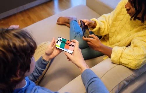 iPhone 15 Pro handheld mockup in a casual gaming setting