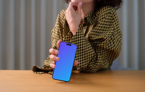 iPhone 15 Pro mockup in a woman's hand with thoughtful pose