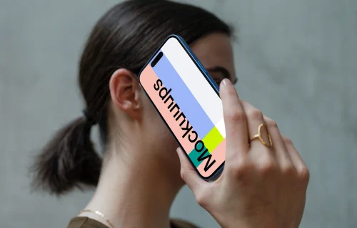 iPhone 16 mockup held in hand against concrete background