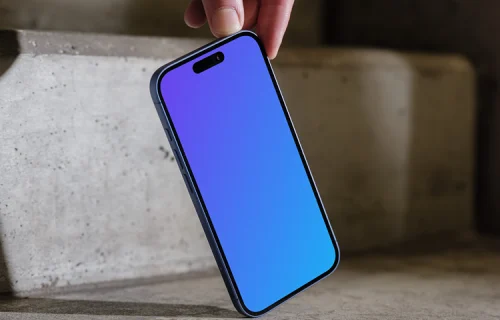 iPhone 16 mockup held on concrete stairs