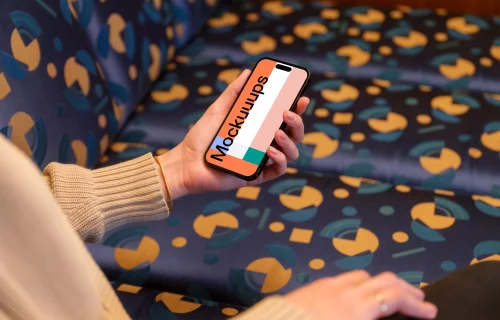 iPhone mockup held by woman’s hand in the lounge 
