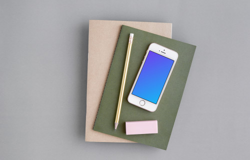 iPhone SE mockup with a green and brown journal