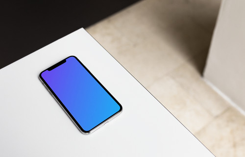 iPhone X mockup on the gray table