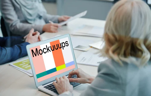 Lady at a conference table using a MacBook Air mockup
