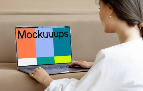 Lady using a MacBook Pro mockup on a sofa