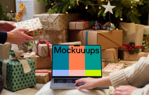 Laptop mockup surrounded by Christmas gifts