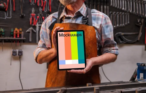 Leather crafter holding an iPad mockup