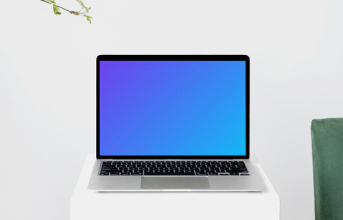 MacBook mockup on a tall white stool with wooden chair arm on the side