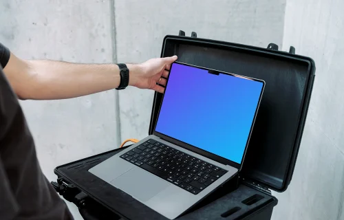 MacBook Pro 14 Mockup with Man Setting Up Display