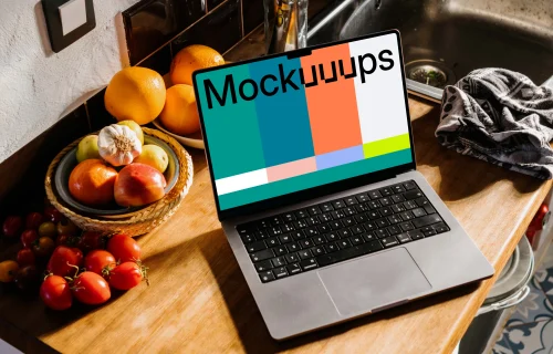 MacBook Pro mockup on a kitchen counter next to bowls of fruits