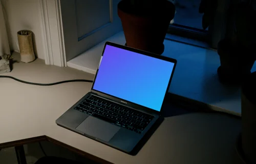 MacBook Pro mockup on a reading table