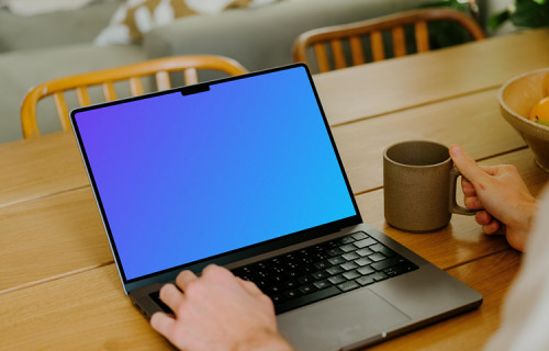 MacBook Pro mockup on a table in front of a user