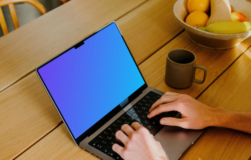 MacBook Pro mockup with a user typing on it.