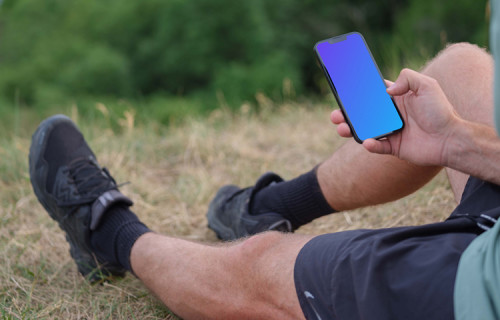 Male hand typing on an iPhone mockup