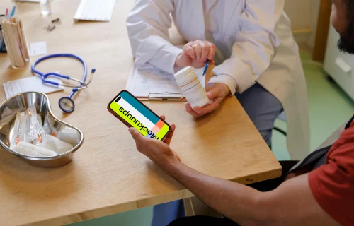 Male patient holding the iPhone mockup