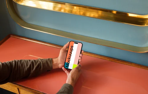 Man holding a phone in the lounge