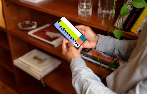 Man holding a phone mockup in the office
