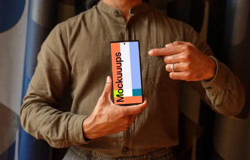 Man in khaki shirt holding a Google Pixel 6 mockup