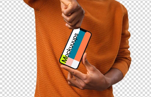 Man in orange sweater holding iPhone mockup from the top