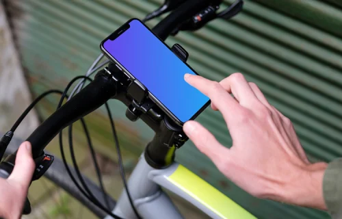 Man on bike next to a garage with iPhone 11 Pro mockup in bike mount