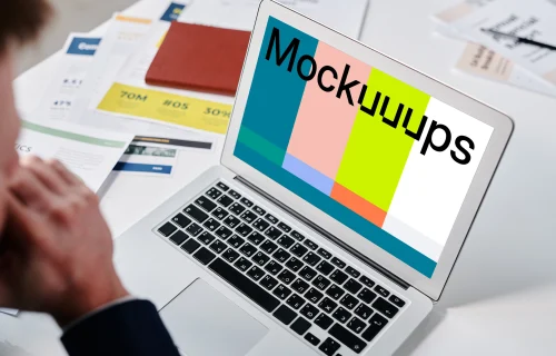 Man sitting at a desk using a MacBook Air mockup