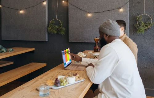 Microsoft Surface Laptop mockup in a restaurant with two users