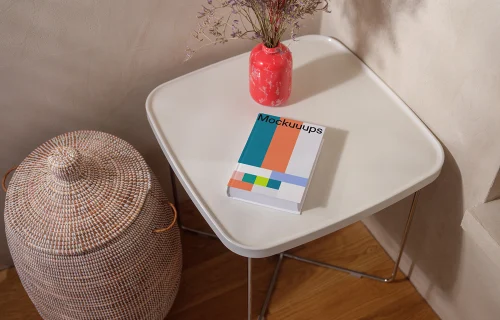 Mockup of a book on a minimalist table with decor