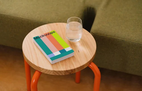 Mockup of a softcover book on a wooden side table