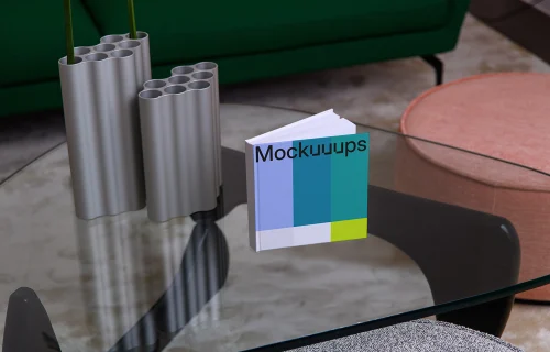 Mockup of a square book on a modern glass coffee table