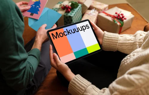 Mockup of a woman holding tablet with a Christmas styling