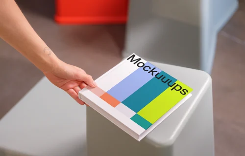 Mockup of square book on modern furniture