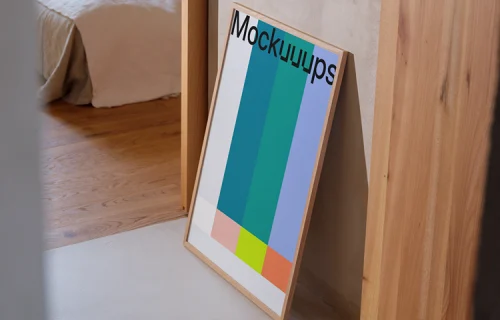 Modern poster mockup leaning against a neutral wall