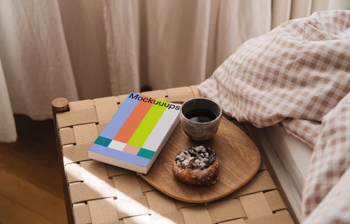 Paperback book mockup on a bedside table with breakfast