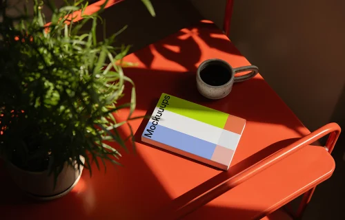 Paperback mockup on a bright red table with natural light